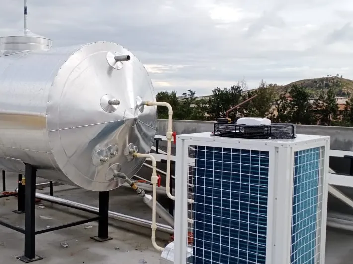 Large horizontal stainless storage tank connected to a commercial heat pump