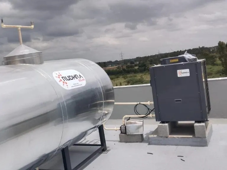 Rudhra Solar horizontal storage tank with a commercial heat pump on a plinth