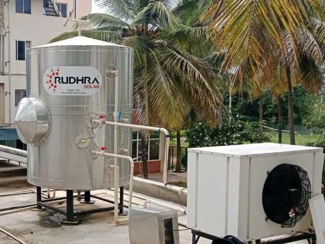 Rudhra Solar vertical stainless tank and domestic heat pump on a residential campus terrace