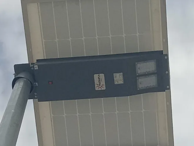 Underside of a Rudhra all-in-one solar street light showing the twin LED modules, housing and solar panel