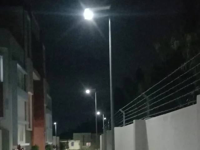 Rudhra solar street lights switched on at night along a campus walkway