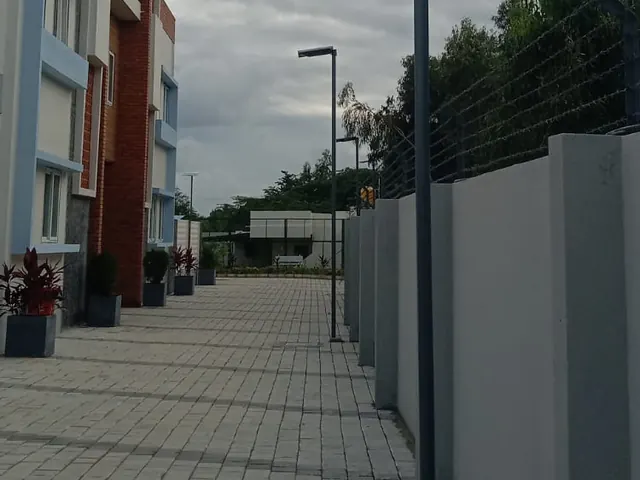 Rudhra solar street lights along a paved campus walkway
