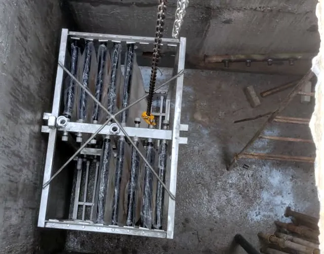 MBR membrane frame lowered by chain hoist into a concrete tank