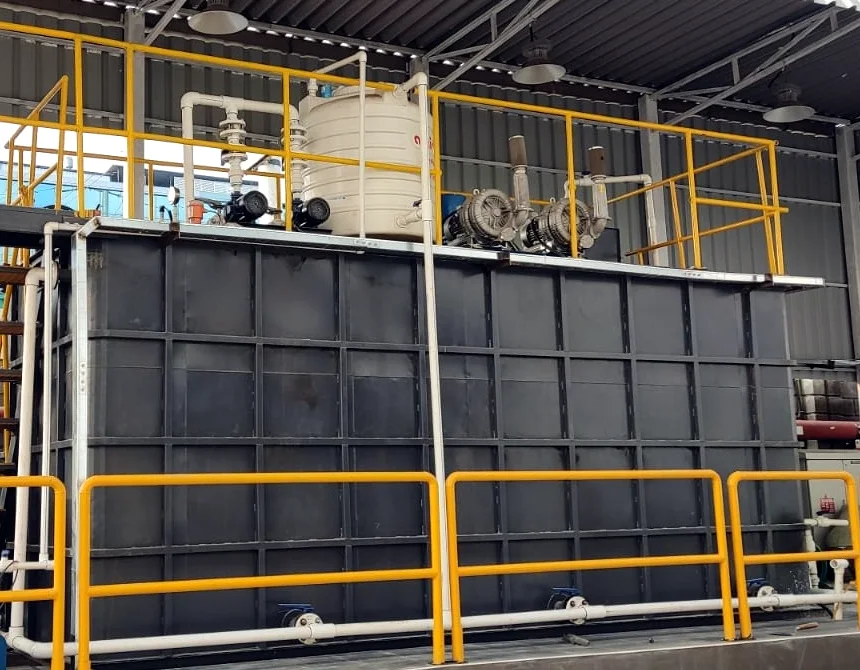 Deur containerised MBBR STP with blowers and dosing tank on top, under a shed