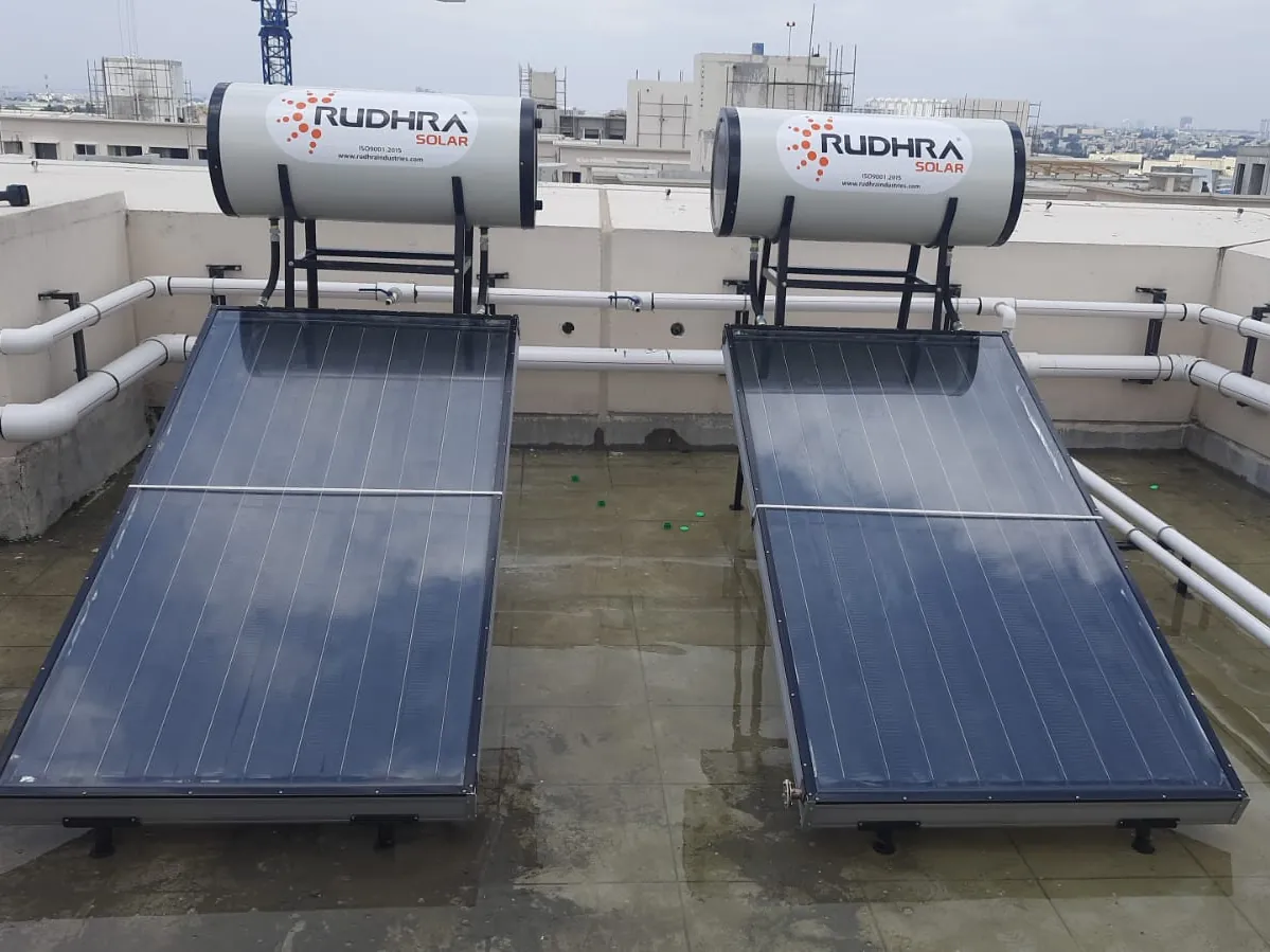 Two Rudhra Solar water heaters on an apartment terrace